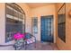 Inviting front porch with decorative door, attractive seating, and colorful flower arrangement, creating a warm entrance at 17342 E Quail Ridge Dr, Fountain Hills, AZ 85268