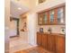 Hallway featuring built-in wooden cabinets for storage and decor display at 17342 E Quail Ridge Dr, Fountain Hills, AZ 85268