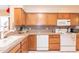 Functional kitchen with wood cabinets, white appliances, and ample counter space at 17342 E Quail Ridge Dr, Fountain Hills, AZ 85268