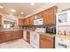 Bright eat-in kitchen features wood cabinetry, white appliances, and recessed lighting at 17342 E Quail Ridge Dr, Fountain Hills, AZ 85268