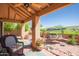 Relaxing covered patio with comfortable seating and a peaceful outdoor view at 17342 E Quail Ridge Dr, Fountain Hills, AZ 85268
