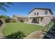 This backyard has an expansive lawn and patio area for relaxing and entertaining at 1839 E Parkside Ln, Phoenix, AZ 85024