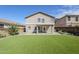 Expansive backyard featuring lush artificial turf, a covered patio and tasteful garden beds at 1839 E Parkside Ln, Phoenix, AZ 85024