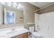 Clean bathroom featuring a single sink vanity, ample mirror space, and a tub with shower combination at 1839 E Parkside Ln, Phoenix, AZ 85024