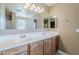 Bathroom with double sink vanity, expansive mirror, and neutral wall color at 1839 E Parkside Ln, Phoenix, AZ 85024