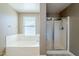 Bathroom showcases a soaking tub, glass-enclosed shower, and natural light from a window at 1839 E Parkside Ln, Phoenix, AZ 85024