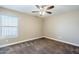 Spacious bedroom with a ceiling fan and ample natural light from a large window at 1839 E Parkside Ln, Phoenix, AZ 85024