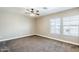 Bright bedroom featuring a ceiling fan and two well-lit windows for a refreshing ambiance at 1839 E Parkside Ln, Phoenix, AZ 85024