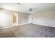 Bright bedroom offers a ceiling fan, carpet floor, and a door leading to a full bathroom at 1839 E Parkside Ln, Phoenix, AZ 85024