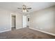 Inviting bedroom with multiple doorways, ceiling fan, and neutral walls offering a versatile space at 1839 E Parkside Ln, Phoenix, AZ 85024