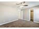 Neutral-toned bedroom with ceiling fan and plush carpeting offers a calm and inviting space at 1839 E Parkside Ln, Phoenix, AZ 85024