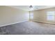 Spacious bedroom featuring neutral walls, carpet flooring, and windows for natural light at 1839 E Parkside Ln, Phoenix, AZ 85024