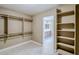 Walk-in closet with shelves, hanging rods, and a doorway leading to the bathroom at 1839 E Parkside Ln, Phoenix, AZ 85024