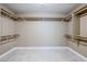 Walk-in closet with built-in shelving and hanging rods for ample storage space at 1839 E Parkside Ln, Phoenix, AZ 85024