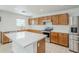 The kitchen features an island, stainless steel appliances, and ample counter space at 1839 E Parkside Ln, Phoenix, AZ 85024