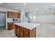 Open-concept kitchen with a central island, ample storage, and seamless flow to the living area at 1839 E Parkside Ln, Phoenix, AZ 85024