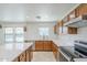 Kitchen featuring stainless steel appliances, white countertops, and natural wood cabinetry at 1839 E Parkside Ln, Phoenix, AZ 85024