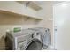Convenient laundry room equipped with modern LG washer and dryer, plus extra storage shelving at 1839 E Parkside Ln, Phoenix, AZ 85024