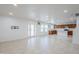 Bright, open-concept living area flows into the kitchen, featuring tile flooring and natural light at 1839 E Parkside Ln, Phoenix, AZ 85024