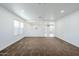 Spacious open-concept living room with natural light and carpet floors at 1839 E Parkside Ln, Phoenix, AZ 85024