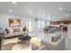 Open living room with neutral finishes, tile flooring, and dining area leading to outdoor access at 1839 E Parkside Ln, Phoenix, AZ 85024