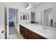 Well-lit bathroom with double sinks, modern fixtures, and sleek vanity at 18429 W Mauna Loa Ln, Surprise, AZ 85388