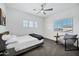 Inviting bedroom with natural light and a cozy gray accent chair by the window at 18429 W Mauna Loa Ln, Surprise, AZ 85388