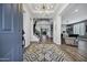 Bright and inviting foyer with a statement light fixture, staircase, and modern flooring at 18429 W Mauna Loa Ln, Surprise, AZ 85388