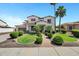 Beautiful two-story home with lush landscaping, a brick walkway, and a three car garage at 18429 W Mauna Loa Ln, Surprise, AZ 85388