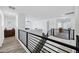 Hallway showing wrought iron railings and luxury vinyl floors at 18429 W Mauna Loa Ln, Surprise, AZ 85388