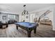 A spacious living area features a pool table, modern lighting, and a view into the front entrance at 18429 W Mauna Loa Ln, Surprise, AZ 85388