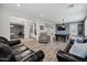 Expansive open living area featuring modern floors, two sofas, pool table, and view into game room at 18429 W Mauna Loa Ln, Surprise, AZ 85388