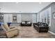 Spacious living room with multiple seating options, shuttered windows, and modern flooring at 18429 W Mauna Loa Ln, Surprise, AZ 85388