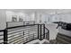 Second floor landing with modern railing overlooking a living room and foyer at 18429 W Mauna Loa Ln, Surprise, AZ 85388
