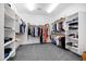 Spacious walk-in closet with custom shelving and hanging rods for optimal organization and storage at 18429 W Mauna Loa Ln, Surprise, AZ 85388