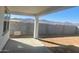 Covered backyard patio with beautiful mountain views in the distance at 18950 W Stella Ave, Waddell, AZ 85355