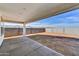 Covered backyard patio with concrete slab and views of the desert landscape at 18950 W Stella Ave, Waddell, AZ 85355
