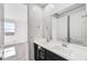 Bathroom with dual sinks, modern fixtures, and a large mirror over black vanity at 18950 W Stella Ave, Waddell, AZ 85355