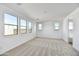 Spacious bedroom with carpet flooring, bright windows, and ample natural light at 18950 W Stella Ave, Waddell, AZ 85355
