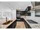 Modern kitchen featuring dark cabinets, granite countertops, stainless steel appliances and island with sink at 18950 W Stella Ave, Waddell, AZ 85355