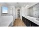 Modern main bathroom featuring double vanity, tiled floors, and separate shower with a glass door at 18950 W Stella Ave, Waddell, AZ 85355
