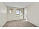 Bright bedroom featuring neutral carpet, and two windows providing plenty of natural light at 19026 W Stella Ave, Waddell, AZ 85355