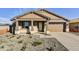 Charming single-story home with stone accents, a two-car garage, and low-maintenance landscaping at 19026 W Stella Ave, Waddell, AZ 85355