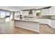 Modern kitchen with white cabinets, granite countertops, stainless steel appliances, and a large island at 19026 W Stella Ave, Waddell, AZ 85355