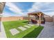 Inviting backyard with artificial turf, a gazebo, and a swing set at 19407 W Pierson St, Litchfield Park, AZ 85340