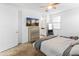 Bright bedroom with carpet flooring, ceiling fan, dresser, and a TV at 19407 W Pierson St, Litchfield Park, AZ 85340
