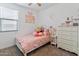 Bright bedroom is decorated with girly decor and carpet flooring at 19407 W Pierson St, Litchfield Park, AZ 85340
