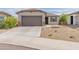 Charming single-story home featuring a well-maintained yard and a two-car garage at 19407 W Pierson St, Litchfield Park, AZ 85340