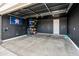 Spacious garage with black walls, a storage rack, and an Houston Astros flag displayed at 19407 W Pierson St, Litchfield Park, AZ 85340