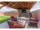 Outdoor entertaining area with cozy seating, a TV, a speaker, and a stylish pergola roof at 19407 W Pierson St, Litchfield Park, AZ 85340